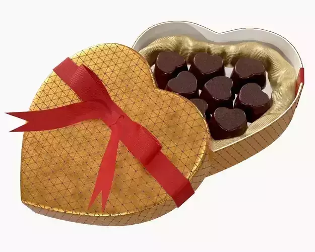 heart shaped box with chocolate and ribbon tied round with bow
