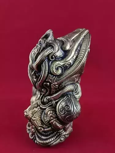Artifact 5 silver figurine with ornate design