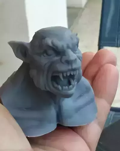 Werewolf person holding figurine of demon
