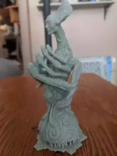 Greeter statue of woman on wooden table