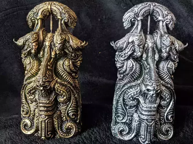 Hybrid pair of ornately carved metal figurines