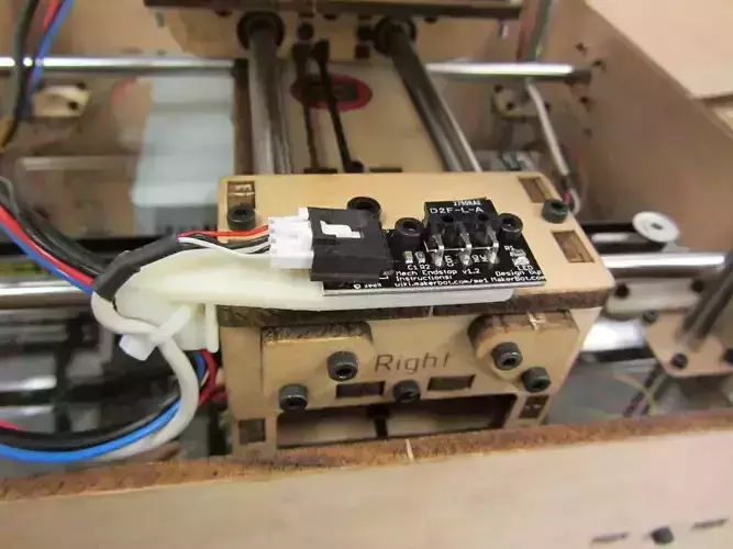 X-axis strain relief and build platform wire guide