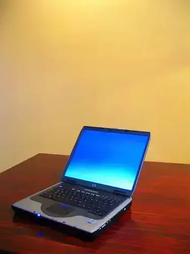 youman laptop on wooden table Free 3D model