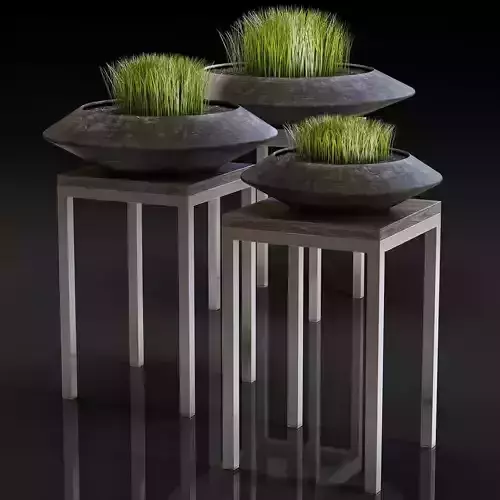 Stylish black vase with grass on a stand