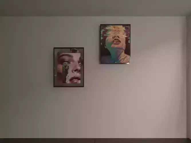 frame two framed pictures hanging on wall