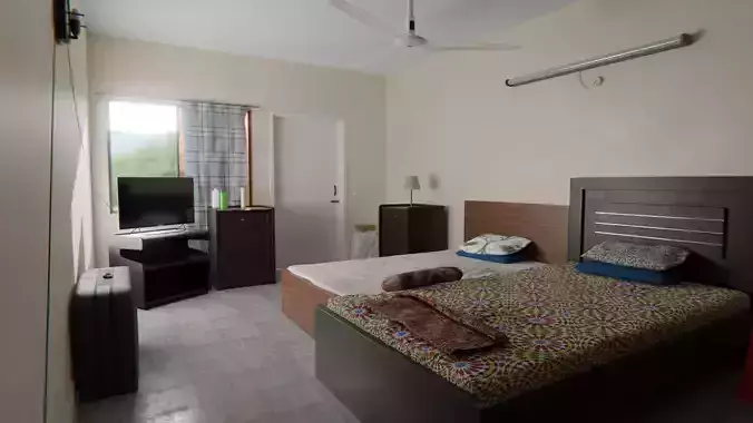 Bedroom with two beds and television