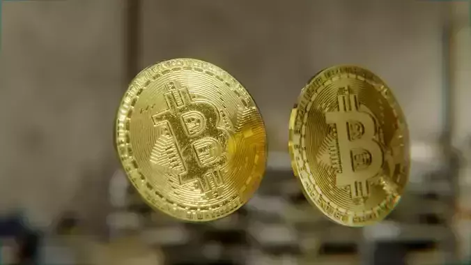 Bitcoin two gold bitcoins on table