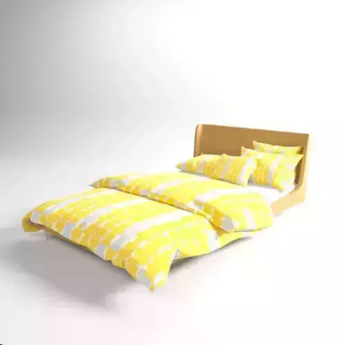 bed with a yellow blanket and pillows