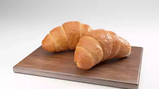 Croissant two croissants on wooden cutting board