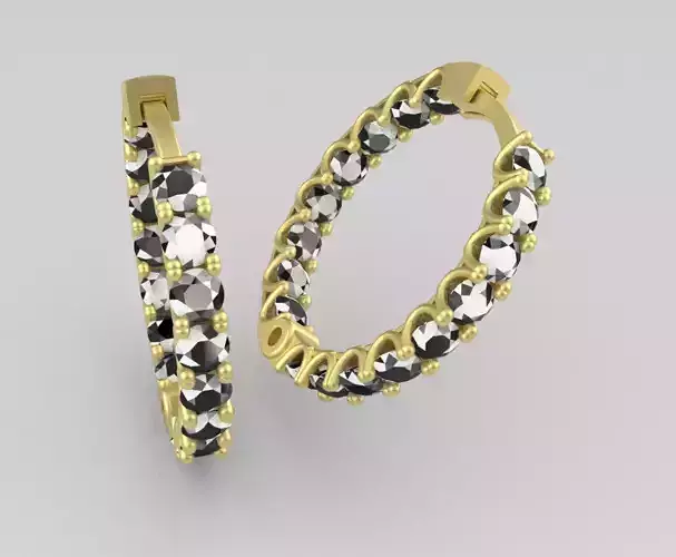 earing two gold hoop earrings with diamonds