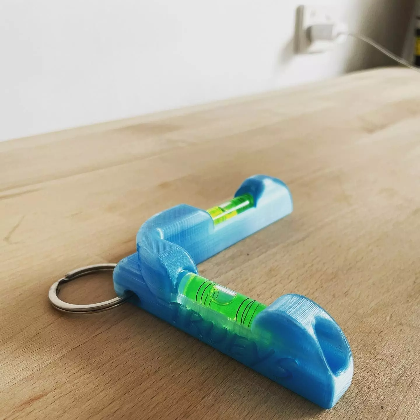 K R L level toy on wooden table 3D print model_0