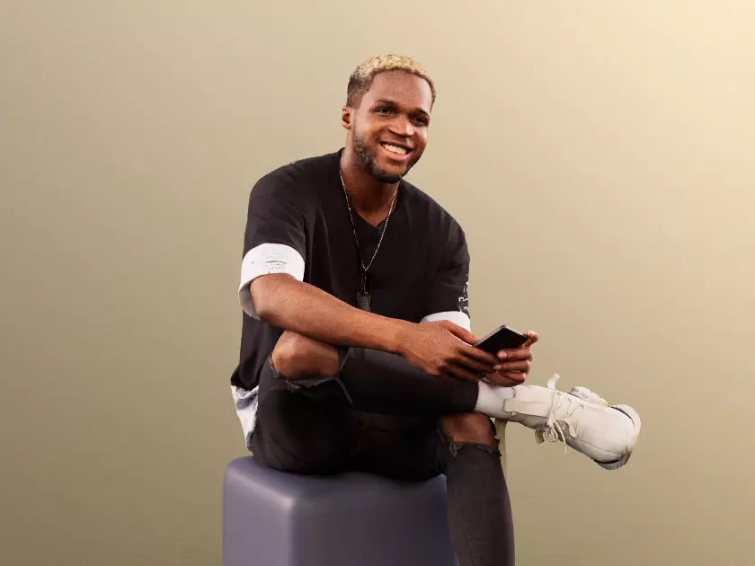Maverick 12153 - Black Man Sitting With Smartphone And Laughing Low-poly 3D model