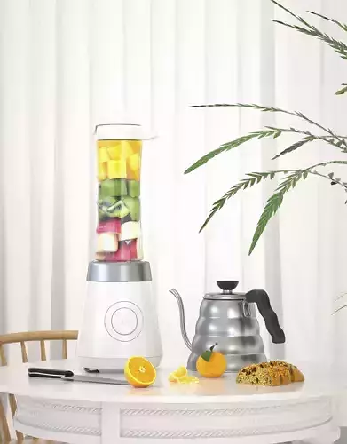 juicer blender on table with fruit in it