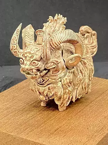 Taotie paper sculpture of horned animal