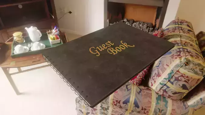 black guestbook book with gold letters