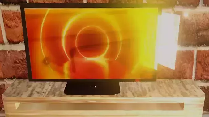 TV model 3d monitor on shelf with brick wall behind it