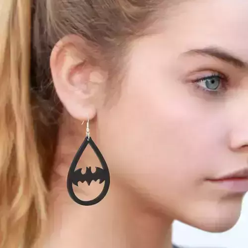 EARING woman wearing batman earrings