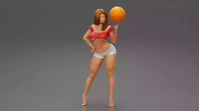 Beautiful Sporty Girl Playing With the Ball on the Basketball