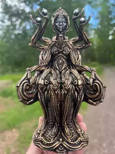 Oracle 3 hand holding ornate metal sculpture