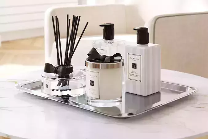 Set of exclusive cosmetics and perfumes on a metal tray