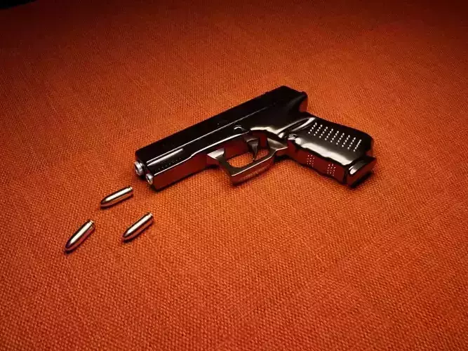 Gun Model with bullets on orange table