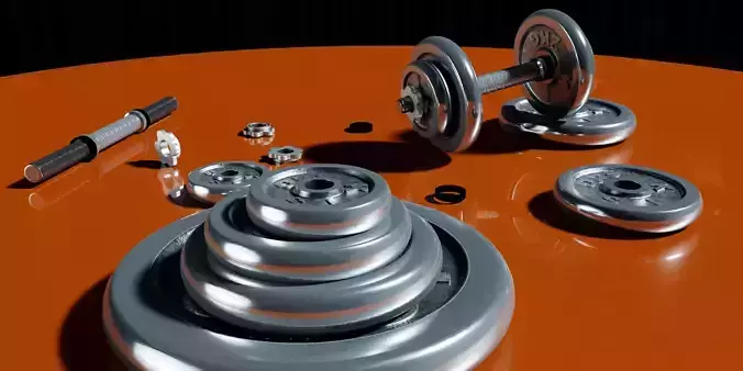 Dumbells set of weights on orange table
