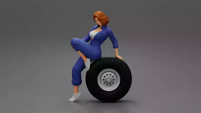 Sexy girl mechanic in suit sitting on a truck tyre without tyre