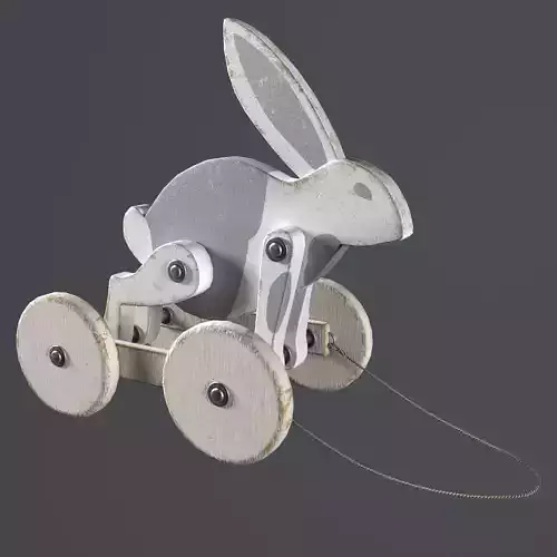 Toy wooden rabbit on wheels