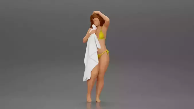 Sexy girl in bikini standing and covering her body by towel