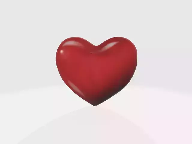 A large glossy red heart-shaped object
