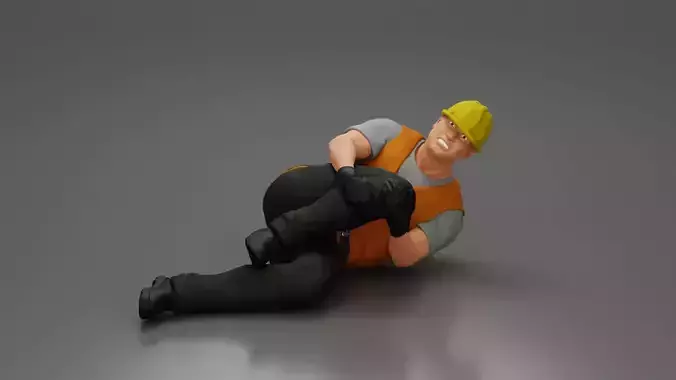 construction worker lying on the floor holding his injured leg