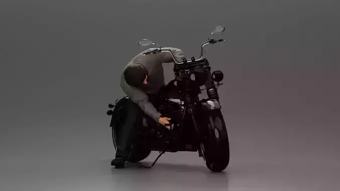 Man sitting on a vintage motorcycle checking it for restoration