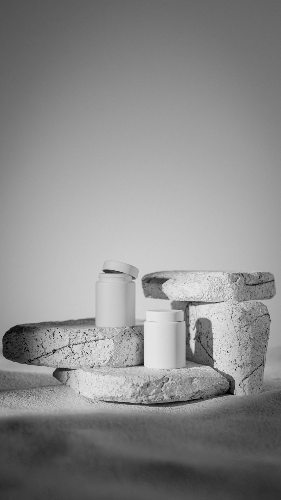 Two black containers on stone surface 3D model_6