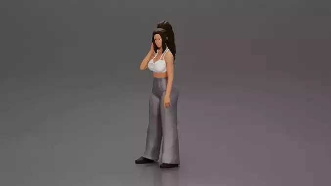 Stylish woman in a crop top and pants standing thoughtfully