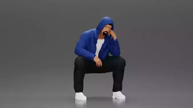 Thoughtful Man in Hoodie Squatting with Hand on His Face