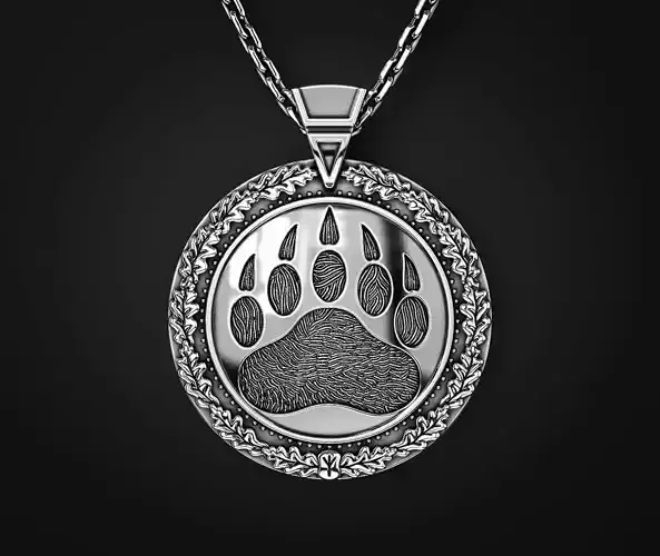 A PENDANT WITH A SLAVIC SYMBOL AND A BEAR S PAW