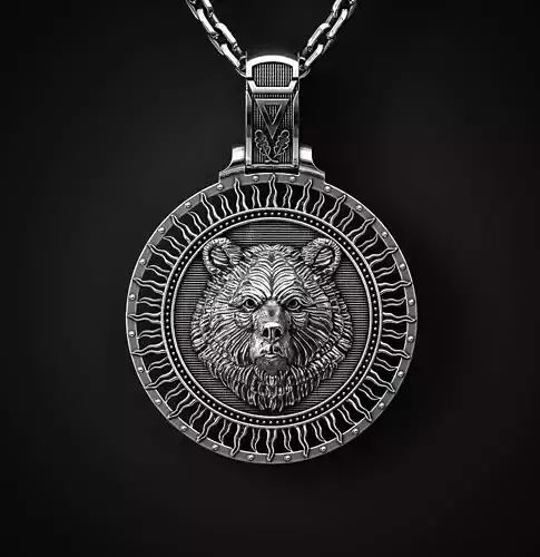 A PENDANT WITH A BEAR S HEAD AND A TREE OF LIFE