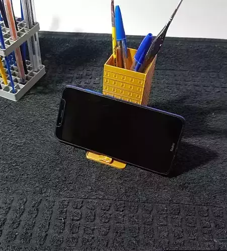Pen holder and cell phone holder in the shape of a building