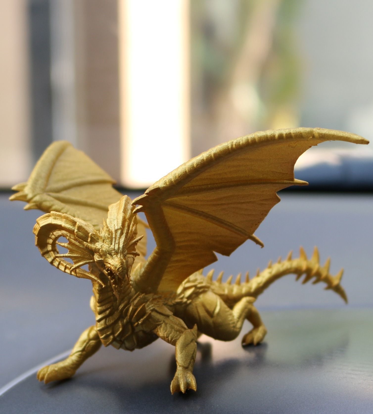 Dragon gold toy on dashboard of car 3D print model_3