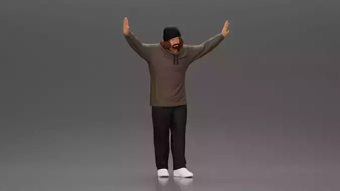 Man wearing hoodie and beanie raises hands looking happy