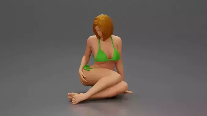 Woman in bikini sitting gracefully on floor with relaxed pose