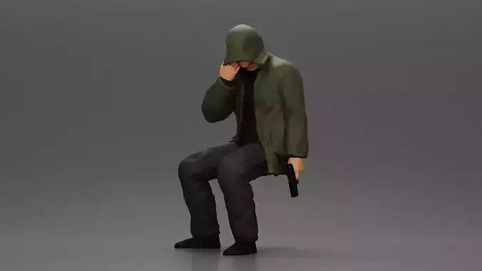 Man in hooded jacket sits alone holding gun feeling troubled
