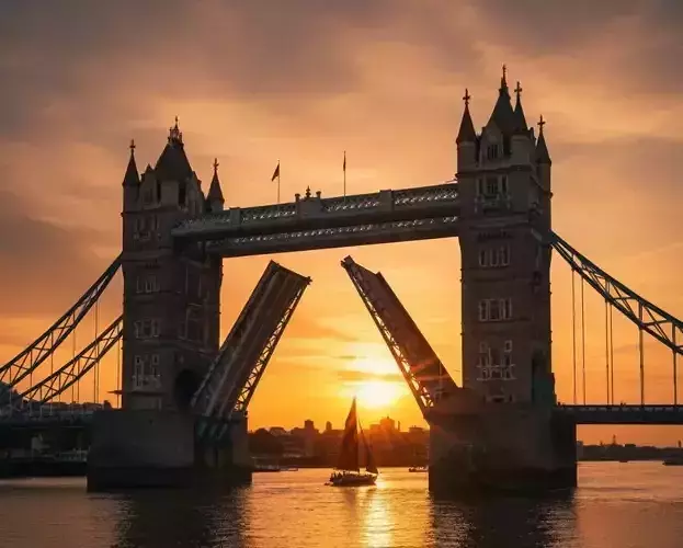 Majestic Tower Bridge at Sunset with Passing Sailboat