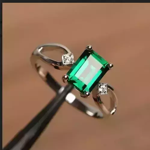 Emerald center engagement ring with earrings