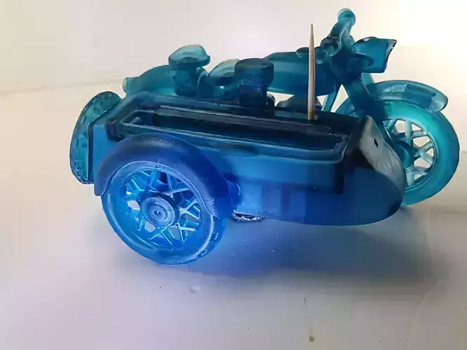 A motorcycle with a sidecar and toothpicks