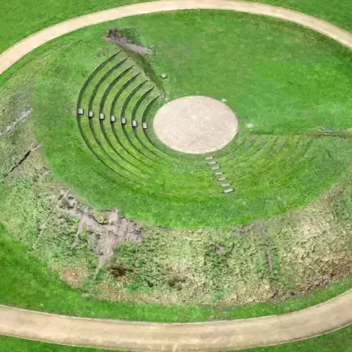 Amfitheater circular structure in middle of grassy field