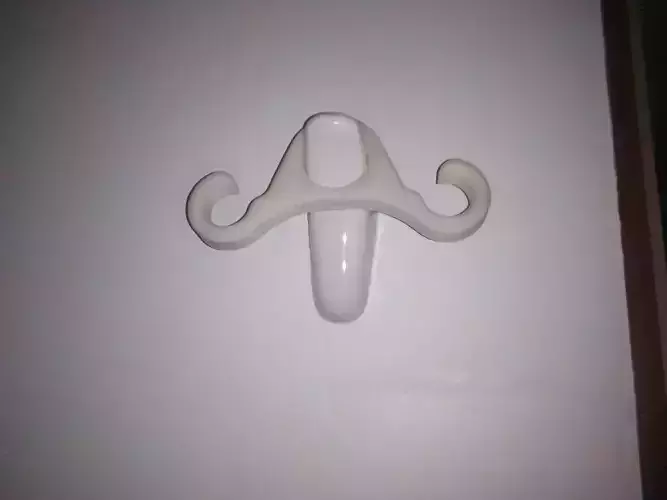 Towels mustache holder on wall