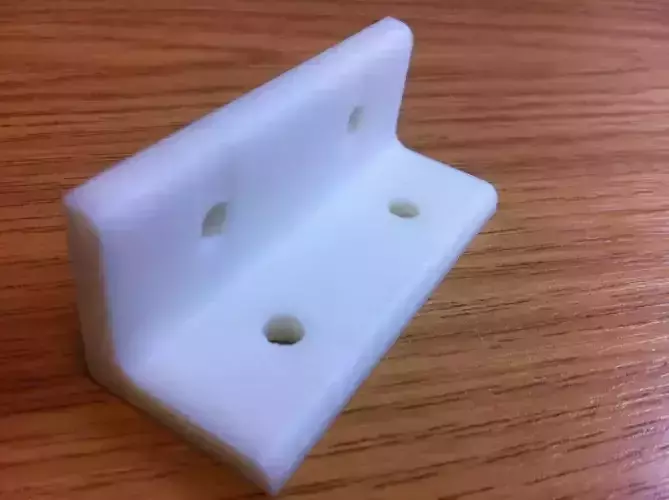 L Bracket plastic on wooden table Free 3D print model